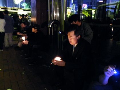 ▲ 직장인으로 보이는 한 시민이 시청 앞 인근에서 촛불을 들고 상념에 잠겨있다.   ⓒ 뉴데일리 조광형 기자 
