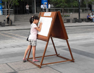 ▲ 사진전을 본 소감을 적는 어린이. ⓒ 뉴데일리