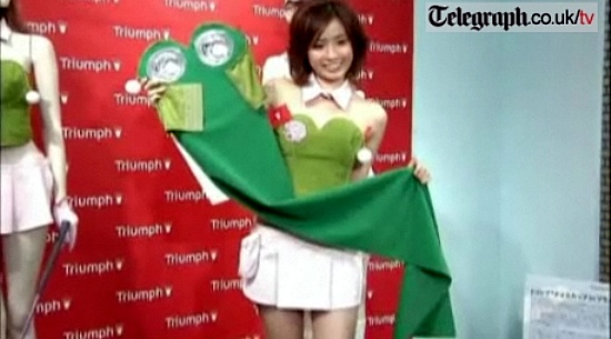 ▲ 모델이 '브라'의 뒷면을 펼쳐 1.5m짜리 퍼팅 매트를 보여주고 있다ⓒ영국 일간 텔레그래프(Telegragh) 캡처