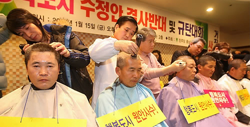 ▲ 양승조 민주당 충남도당 위원장 등 민주당 충남도당 관계자들이 15일 천안 웨딩코리아에서 행복도시 수정안을 반대하며 삭발을 하고 있다 ⓒ연합뉴스