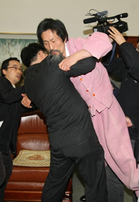 ▲ 민주노동당 강기갑 대표가 '국회 폭력' 사태에 대해 14일 서울 양천구 남부지법에서 무죄 선고를 받았다. 사진은 지난 2009년 1월 5일 강대표가 박계동 국회 사무총장실을 방문해 원탁 위에 올라가 경위들의 강제해산 시도에 대해 거칠게 항의하는 모습 ⓒ 연합뉴스