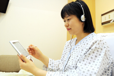 ▲ 삼성서울병원에서 한 환자가&nbsp; e-Book 서비스로 책을 읽고 있다. ⓒ 뉴데일리