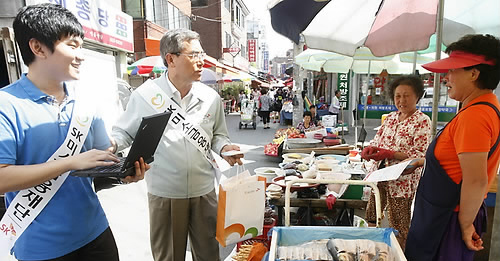 ▲ SK그룹 미소금융재단 신헌철 이사장이 서울시 금천구 현대시장을 찾아 출장 상담을 하고 있다. ⓒ 연합뉴스