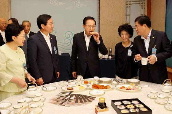 ▲ 이명박 대통령이 14일 오전 청와대에서 열린 국무회의에 앞서 참석자들과 함께 상주 삼백곶감 등 농식품부가 전시한 전통 추석선물용 다과를 시식하고 있다.ⓒ청와대 제공