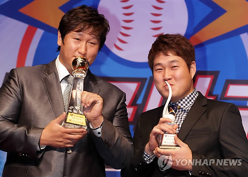 ▲ 25일 오후 그랜드인터콘티넨탈 호텔에서 열린 CJ마구마구 프로야구 2010 최우수 선수ㆍ최우수 신인선수 시상식에서 최우수 선수상을 수상한 이대호와 최우수 신인선수상을 수상한 양의지가 트로피에 입을 맞추고 있다ⓒ연합뉴스