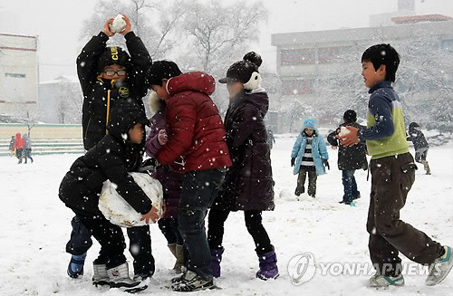 ▲ 13일 강원 태백지역에 함박눈이 내리는 가운데 황지초등학교 학생들이 눈밭으로 변한 운동장에서 눈사람을 만들며 즐거운 한때를 보내고 있다ⓒ연합뉴스