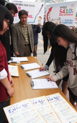 ▲ 최저임금 시간당 5410원을 요구하는 서명운동에 한 여학생이 참가하고 있다. ⓒ 뉴데일리