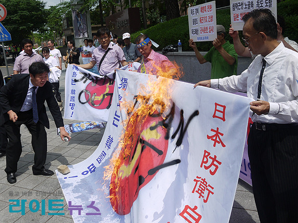 ▲ 라이트코리아 등 시민단체 회원들이 2일 오후 일본대사관 앞에서 일본정부의 방위백서 '독도영유권 표기'에 항의하는 집회를 열고 있다. 사진은 대형 일장기를 화형에 처하는 퍼포먼스.ⓒ 사진 라이트코리아 제공