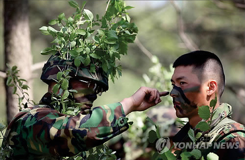 ▲ 해병대에 복무 중인 배우 현빈이 훈련을 받기에 앞서 위장 크림을 바르고 있다.