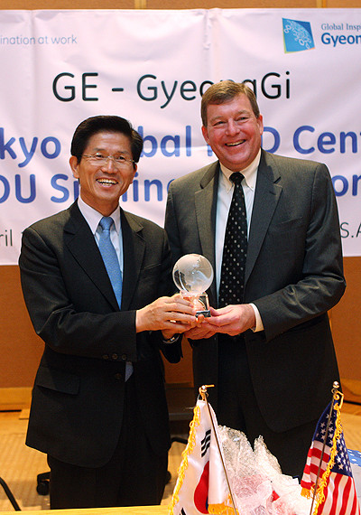 ▲ 지난 4월 19일(현지시간) 미국 코네티컷주에 있는 GE본사를 찾은 김문수 지사가 제임스 스슈사장과 3천만달러 규모의 투자유치 협약을 체결한 후 선물을 교환하고 있다. ⓒ 뉴데일리