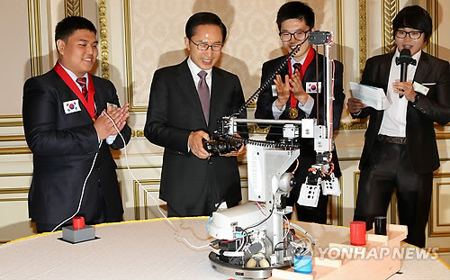 ▲ 이명박 대통령이 21일 청와대에서 열린 기술-기능인 초청 오찬에 앞서 런던기능올림픽에서 MVP를 수상한 '모바일 로보틱스'를 시연해보며 즐거워하고 있다. ⓒ연합뉴스