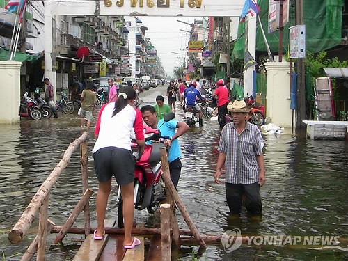 ▲ 태국 방콕 북쪽의 빠툼타니주 랑싯 주민들이 홍수로 물에 잠긴 거리를 힘겹게 헤처나가고 있다. ⓒ 연합뉴스