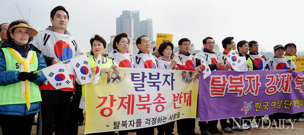 ▲ 17일 오전 서울 마포구 난지천공원 내 난지광장에서 열린 '탈북자 강제북송반대 범국민 걷기대회'에서 참석자들이 '탈북자 강제북송 반대' 문구가 적힌 현수막을 들고 있다. ⓒ뉴데일리