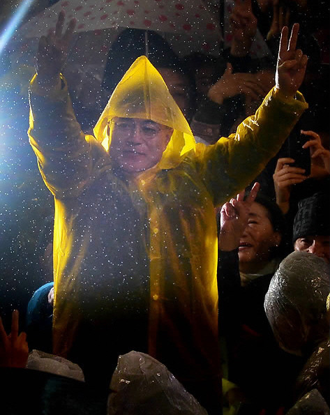 ▲ 겨울비가 내리는 가운데 민주통합당 문재인 대선후보가 14일 오후 부산 서면 쥬디스태화백화점 앞 유세장 입장해 손을 들어 인사하고 있다. ⓒ 연합뉴스