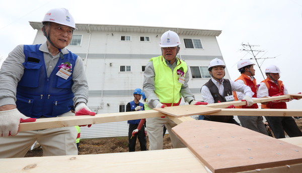 ▲ 제2차 [수원 해비타트-SK행복마을] 첫 주택의 골조를 세우는 모습. 사진 좌측부터 정근모 해비타트 이사장, 최신원 SKC 회장.