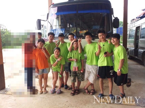 ▲ 아이들은 모두 해맑은 표정을 짓고 있었다. 맨 왼쪽에 있는 여자 아이만 주황색 반팔 티셔츠를 입었고, 나머지는 모두 연두색 반팔 티셔츠 차림이다. 이 티셔츠들은 한국인 관광객으로 위장하기 위해 국내에 있는 북한인권단체로부터 협조받은 단체복이다. 강제북송된 [꽃제비(탈북 고아)] 출신 탈북자 9명이, 지난달 10일 라오스 경찰에게 붙잡히기 2시간 전에 찍은 사진이 공개됐다. 한국 대사관이 있는 라오스 수도 비엔티안으로 향하는 버스 앞에서의 모습이다.
