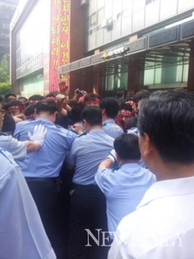 ▲ ▲ 이건호 행장의 출근을 저지하는 KB국민은행 노조원들이 이 행장의 수행원, 방호원들과 몸싸움을 벌이고 있다.