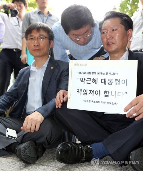 ▲ 21일 오후 통합진보당 이상규(좌), 민주당 정청래 의원을 비롯한 국정조사 특위 야당위원들이 청와대에 진입하려다 경찰에 막혀 길바닥에 눌러앉아 있다.ⓒ연합뉴스