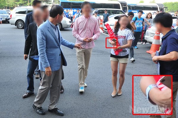 ▲ 서울시 여자 공무원이 공무용 아구장 출입 표찰을 차고 경기 시작을 기다리고 있다.