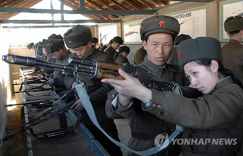 ▲ 북한 여성 노농적위대원이 총기를 점검하고있는 모습. ⓒ연합뉴스