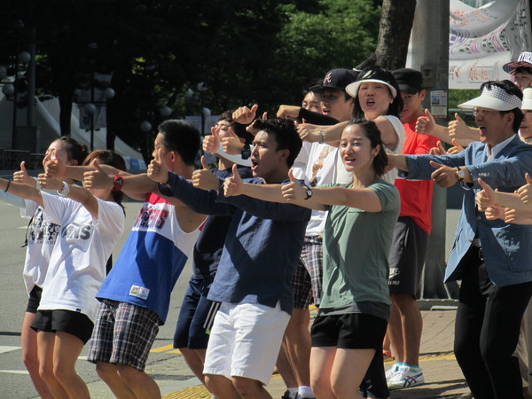 ▲ 25일 경기 평택 비전2동에서 열린 새누리당 유의동 후보 집중 유세에서 자원봉사자들이 로고송에 맞춰 '기호 1번'을 상징하는 엄지손가락을 내세우며 율동을 하고 있다. ⓒ정도원 기자