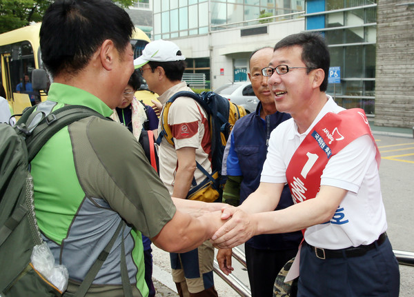▲ 경기 김포 보궐선거에 출마한 새누리당 홍철호 후보가 27일 등산을 떠나는 김포 지역 산악회 회원들을 배웅하고 있다. ⓒ홍철호 후보 선거사무소 제공
