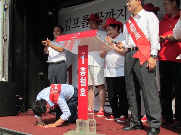 ▲ 29일 김포 사우동에서 열린 유세에서 새누리당 홍철호 후보가 발언에 앞서 청중들을 향해 큰절로 인사하고 있다. ⓒ정도원 기자