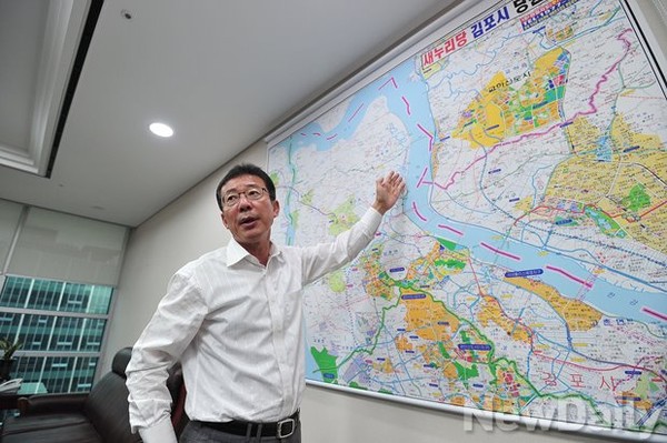 ▲ 새누리당 홍철호 의원이 김포의 교통 문제를 설명하며 의원실 한쪽 벽에 걸린 김포시 지도 위에서 한강평화로(해강안도로) 위치를 짚어보이고 있다. ⓒ정재훈 기자