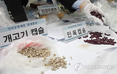 ▲ 지난해 3월 인천국제공항 공항세관 휴대품 유치창고에서 인천공항세관 직원들이 통관이 불허된 인육캡슐, 개고기캡슐 등을 살펴보고 있다. ⓒ연합뉴스