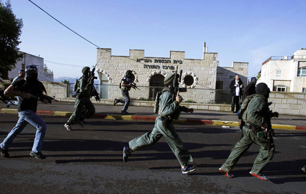 ▲ 묻지마 도끼 테러가 일어난 시나고그로 달려가는 이스라엘 보안군. ⓒ이스라엘 하레츠 보도화면 캡쳐