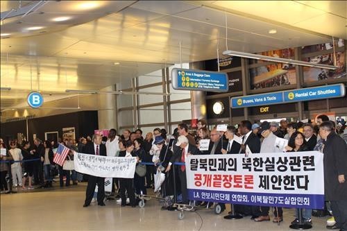 ▲ 이날 신은미씨가 남편과 함께 로스앤젤레스(LA) 국제공항 입국하자, 재미 보수·진보단체들이 고함을 지르고, 미리 준비한 플래카드를 펼쳐 보이는 등 뒤엉켜 소란을 빚었다. ⓒ사진 연합뉴스