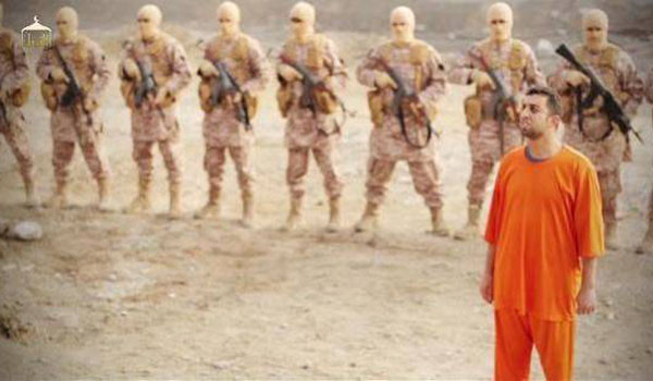 ▲ 요르단 공군 조종사 뒤에 총을 들고 포즈를 취한 테러조직 ISIS 조직원들. ⓒ마즈 알카사스베 화형 동영상 캡쳐