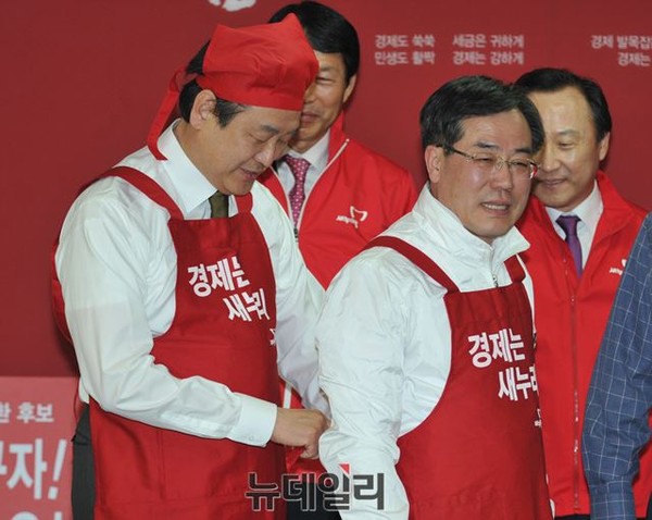 ▲ 지난달 31일 여의도 새누리당 당사에서 열린 새누리당 정책발표회에서 김무성 새누리당 대표가 4.29 재보선 광주 서구을에 출마한 정승 후보의 앞치마 끈을 묶어주고 있다. ⓒ뉴데일리 이종현 기자