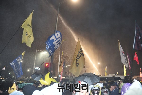 ▲ 18일 오후 서울시청 앞 서울광장에서 세월호 추모 집회를 마친 일부 시위대가 청와대 앞으로 불법 행진을 시도하면서 이를 막는 경찰과 심한 몸싸움을 벌였다. 경찰이 해산명령에 응하지 않는 시위대를 향해 물대포를 발사하고 있다. ⓒ 뉴데일리 이종현 기자