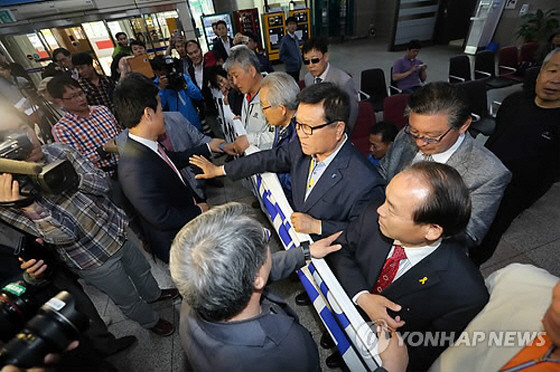 ▲ 새정치민주연합 문재인 대표가 광주로 향한 4일, 20여 명의 광주시민이 광주공항 승강장에 모여 문재인 대표를 규탄하는 현수막을 펼친 채 항의를 준비하고 있던 중 문재인 대표 측 지지자들인 친노 세력들과 충돌하고 있다. ⓒ연합뉴스 사진DB