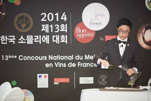 ▲ 지난해 개최된 한국 소믈리에 대회에서 한 참가자가 와인 서비스 능력을 평가하는 실기시험을 진행하고 있다. ⓒ소펙사코리아