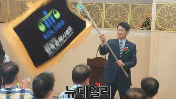 ▲ 출범식에서 깃발을 휘두르고 있는 민병진 코로스 대표이사.ⓒ뉴데일리 DB