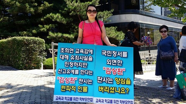 ▲ 교학연 김순희 대표가 ‘조희연 교육감 선고유예 판결’을 비판하는 내용의 손 피켓을 들고 서울고등법원 앞에서 시위를 벌이고 있다. ⓒ 교학연 사진 제공
