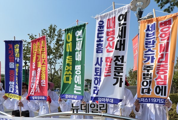 ▲ 윤도흠 연세대 세브란스 병원장 사퇴를 촉구하는 만장기를 든 엄마부대봉사단 회원들. ⓒ뉴데일리 정상윤 기자