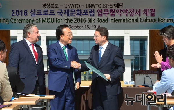 ▲ 김관용 경북도지사(왼쪽 두번째)가 UNWTO 탈렙 리파이 사무총장과 '실크로드 국제문화포럼'개최와 관련한 협약서에 서명 후 악수를 나누고 있다.ⓒ경북도 제공