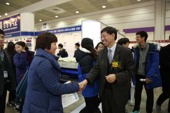 ▲ 서울 강남구 코엑스에서 3일 개최된 '2016학년도 정시 대학입학정보박람회'에서 입학상담에 나섰던 구기헌 상명대 총장(오른쪽)이 한 학부모를 격려하고 있다.