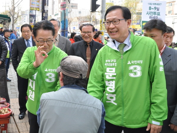 ▲ 인천 부평갑 당선무효소송 및 선거무효소송을 제기하기로 한 국민의당 문병호 의원이 이번 총선에서 지역 유권자와 인사를 나누고 있는 가운데, 문병호 의원을 지원하러 온 박지원 의원이 기호 3번을 상징하는 손동작을 들어보이고 있다. ⓒ뉴시스 사진DB
