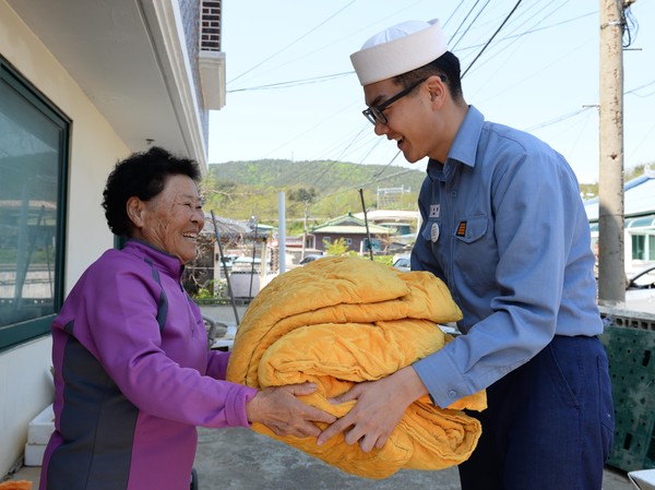 ▲ 가정의 달을 이틀 앞둔 4월 29일 해군 1함대 보급지원대대 정대현 병장(23세/사진 우측)이 안순이(76세) 할머니 댁을 방문해 세탁한 이불을 전달하고 있다. ⓒ해군 제공