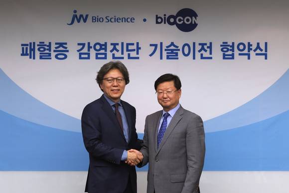 ▲ JW바이오사이언스 노용갑 대표(오른쪽)가 의약바이오컨버젼스연구단 김성훈 단장(왼쪽)과 패혈증 감염 조기진단 기술 이전 계약을 체결하고 있다. ⓒJW그룹 제공