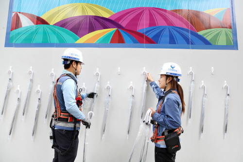 ▲ 삼성물산 래미안 블레스티지 공사현장 가림벽에는 소나기를 피하기 위한 우산이 늘 비치돼 있다. 지역주민들이 자유롭게 우산을 쓰고, 제자리에 갖다 두기만 하면 된다. ⓒ 삼성물산