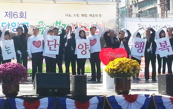 ▲ 지난해 행사에서 류한우 군수와 참가자들이 이웃사랑을 실천하자는 하트 모양을 만들고 있다.ⓒ단양군