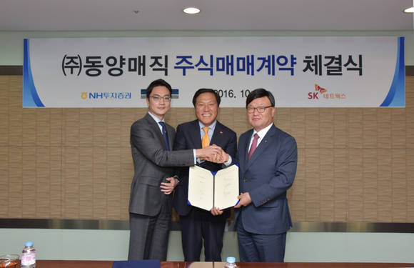 ▲ 문종훈 SK네트웍스 사장(가운데)이 김원규 NH투자증권 대표(오른쪽), 이상호 글랜우드PE 대표와 동양매직 주식매매 계약을 체결하고 악수를 나누고 있는 모습.ⓒSK네트웍스