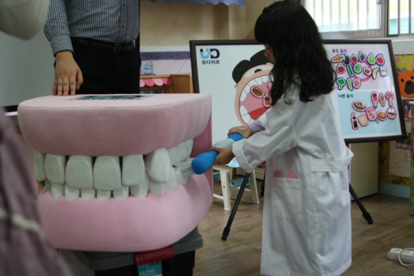 ▲ 지난 13일 이미지큰샘어린이집에서 올바른 칫솔질 교육 후 한 어린이가 구강모형을 이용해 직접 칫솔질을 해보고 있다.ⓒ유디치과