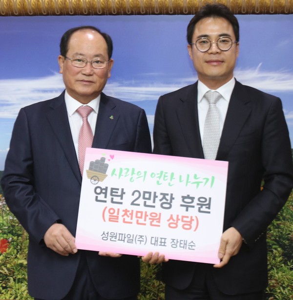 ▲ 장태순 성원파일(주) 대표(오른쪽)가 류한우 단양군수에게 연탄을 전달하고 있다.ⓒ단양군