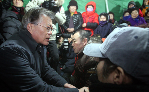 ▲ 문재인 전 더불어민주당 대표가 15일 오후 전남 여수시 교동 여객선터미널 맞은편 여수수산시장 화재 피해 현장을 둘러본 뒤 상인들과 면담하고 있다.ⓒ뉴시스